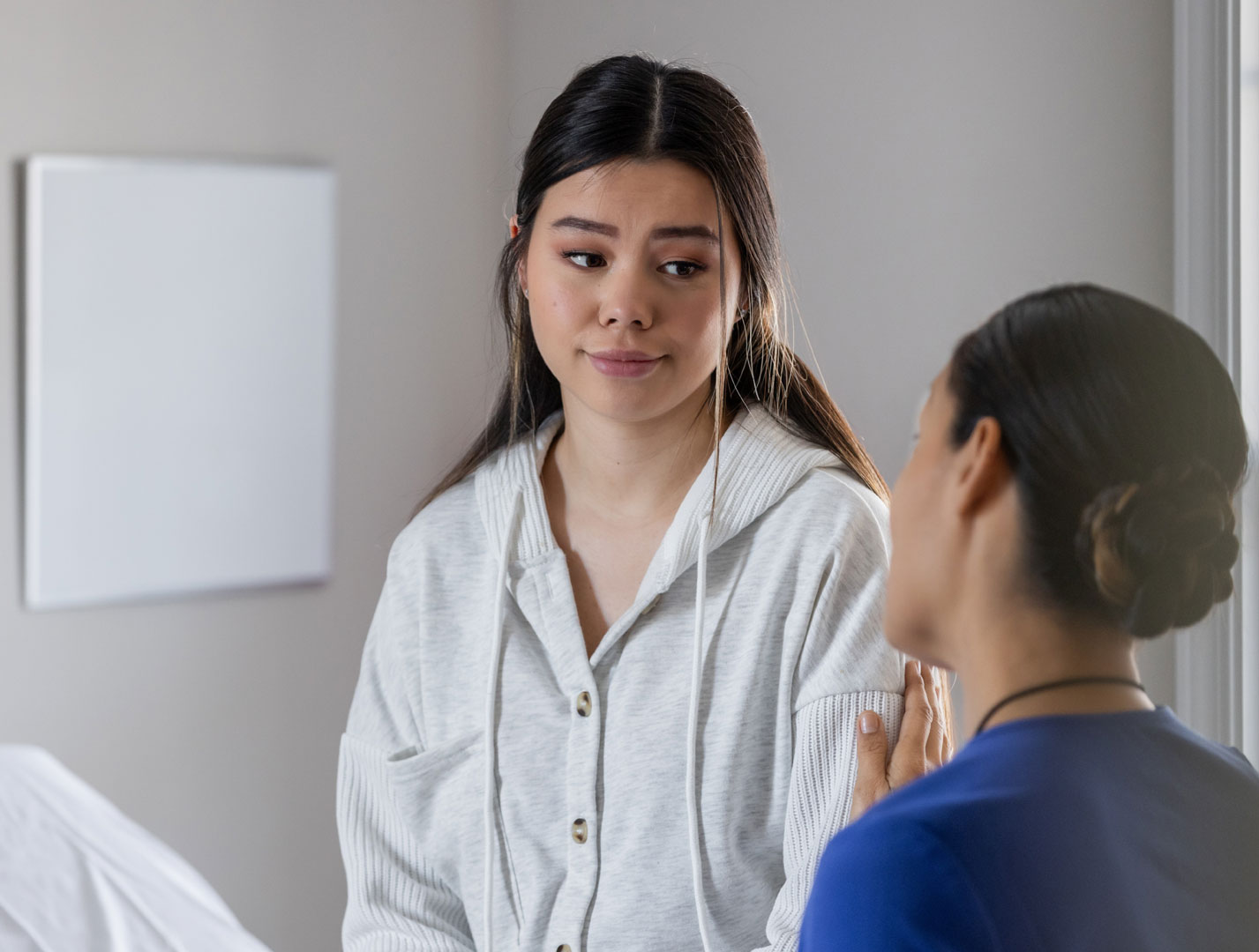 Patient discusses her concerns with nurse.