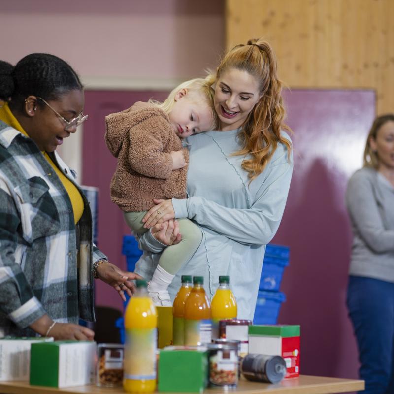 A mother and her daughter receiving juice from the foodbank.