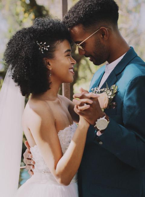Young Black couple, dancing on their wedding day.
